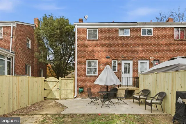 a backyard of a house with table and chairs