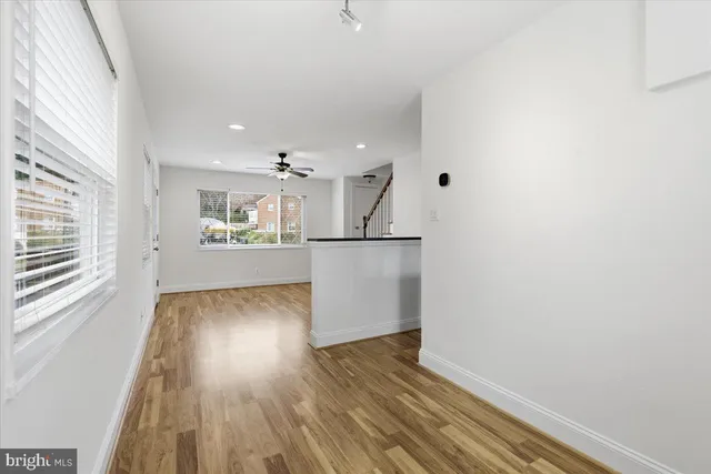 a view of a kitchen with wooden floor and a window