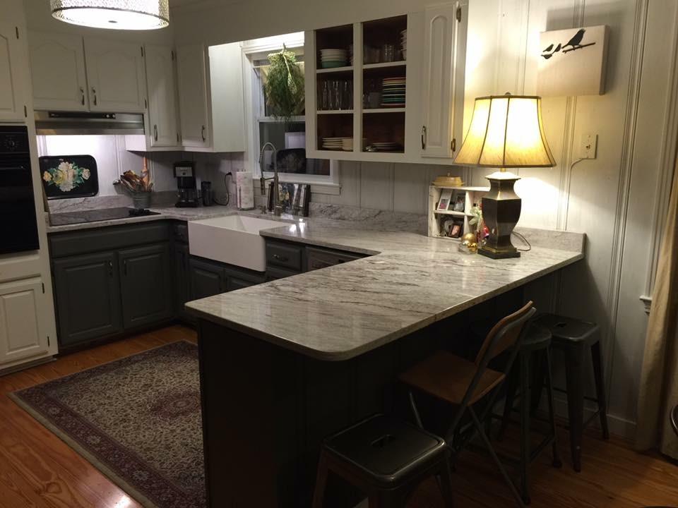489 Ab Wade Road Portland, TN 37148 - Photo 2 of 23 a kitchen with a sink a stove and a wooden cabinets