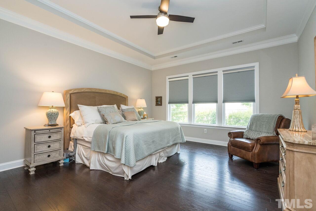 129 Damsire Way Cary, NC 27513 - Photo 19 of 32 a bedroom with a bed couch and a large window