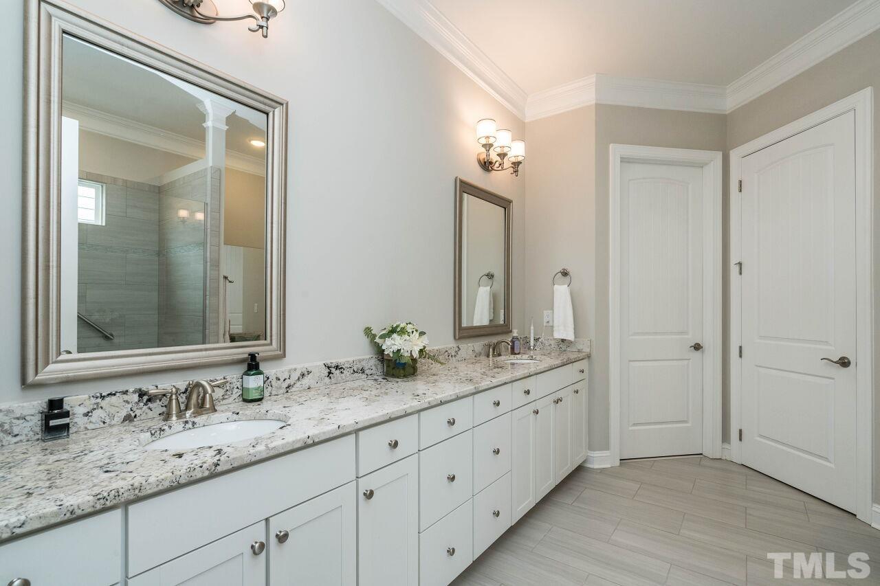 129 Damsire Way Cary, NC 27513 - Photo 21 of 32 a bathroom with a granite countertop double vanity sink mirror and
