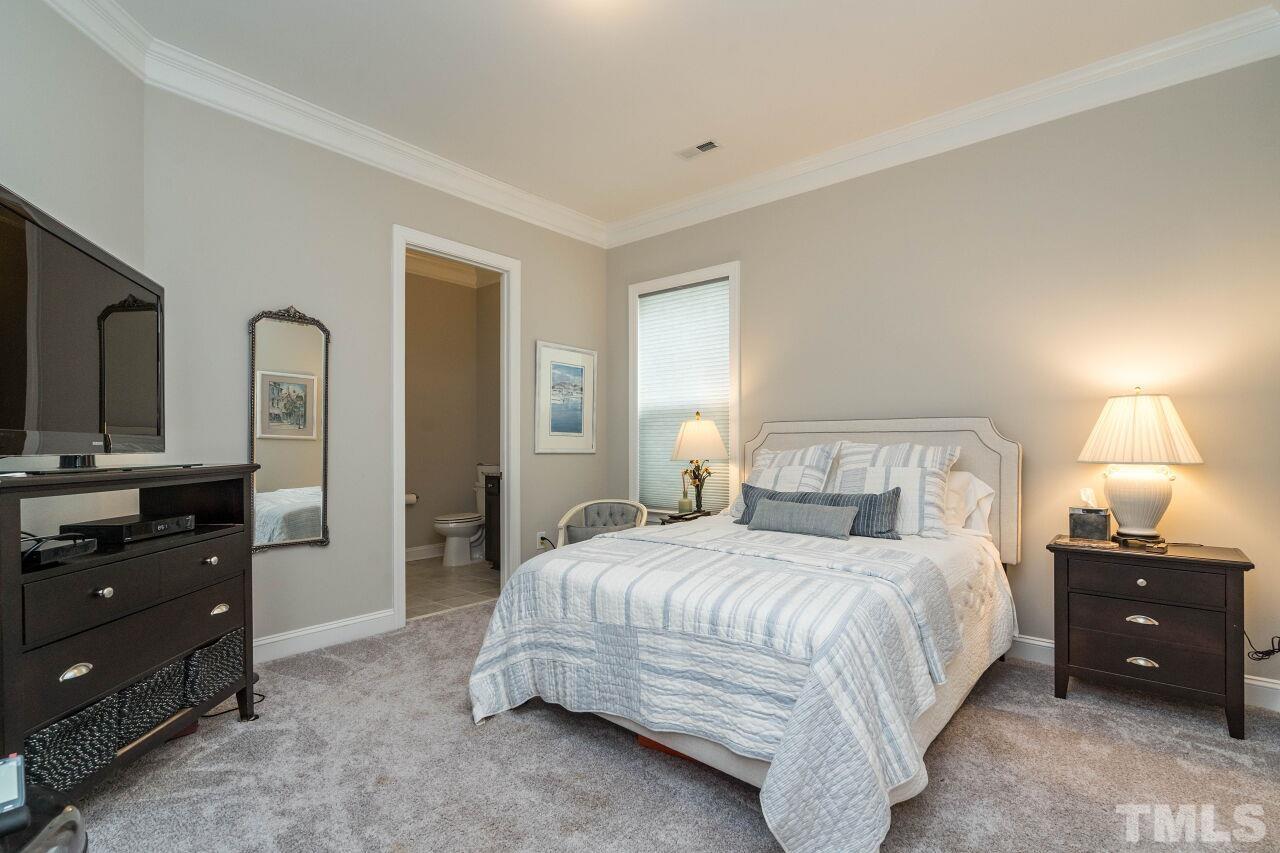 129 Damsire Way Cary, NC 27513 - Photo 23 of 32 a bedroom with a bed and a dresser