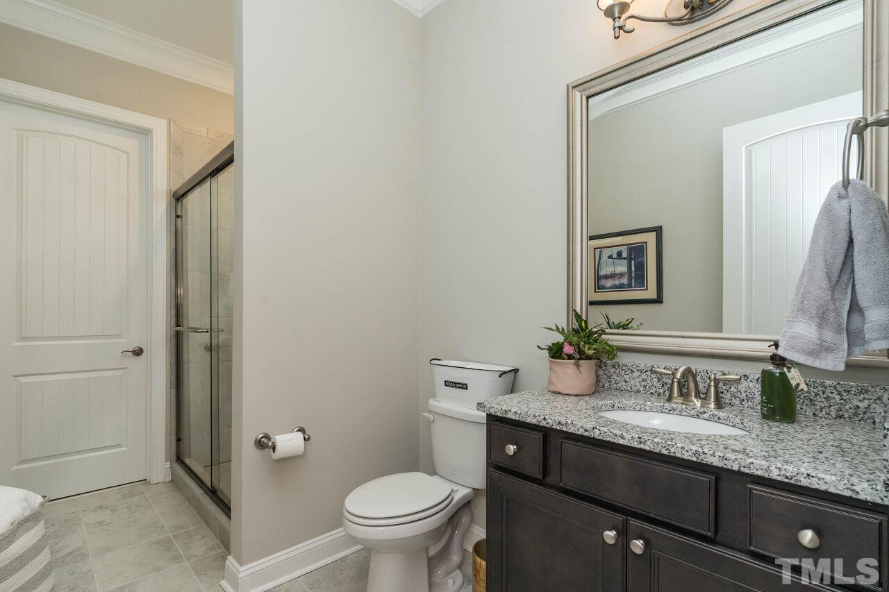 129 Damsire Way Cary, NC 27513 - Photo 24 of 32 a bathroom with a granite countertop sink toilet and mirror