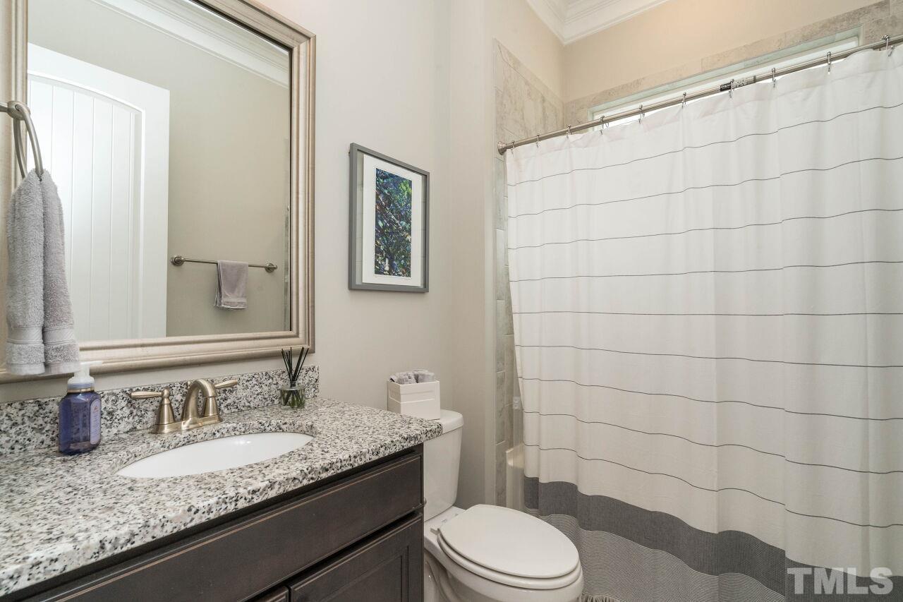 129 Damsire Way Cary, NC 27513 - Photo 26 of 32 a bathroom with a granite countertop sink toilet and shower