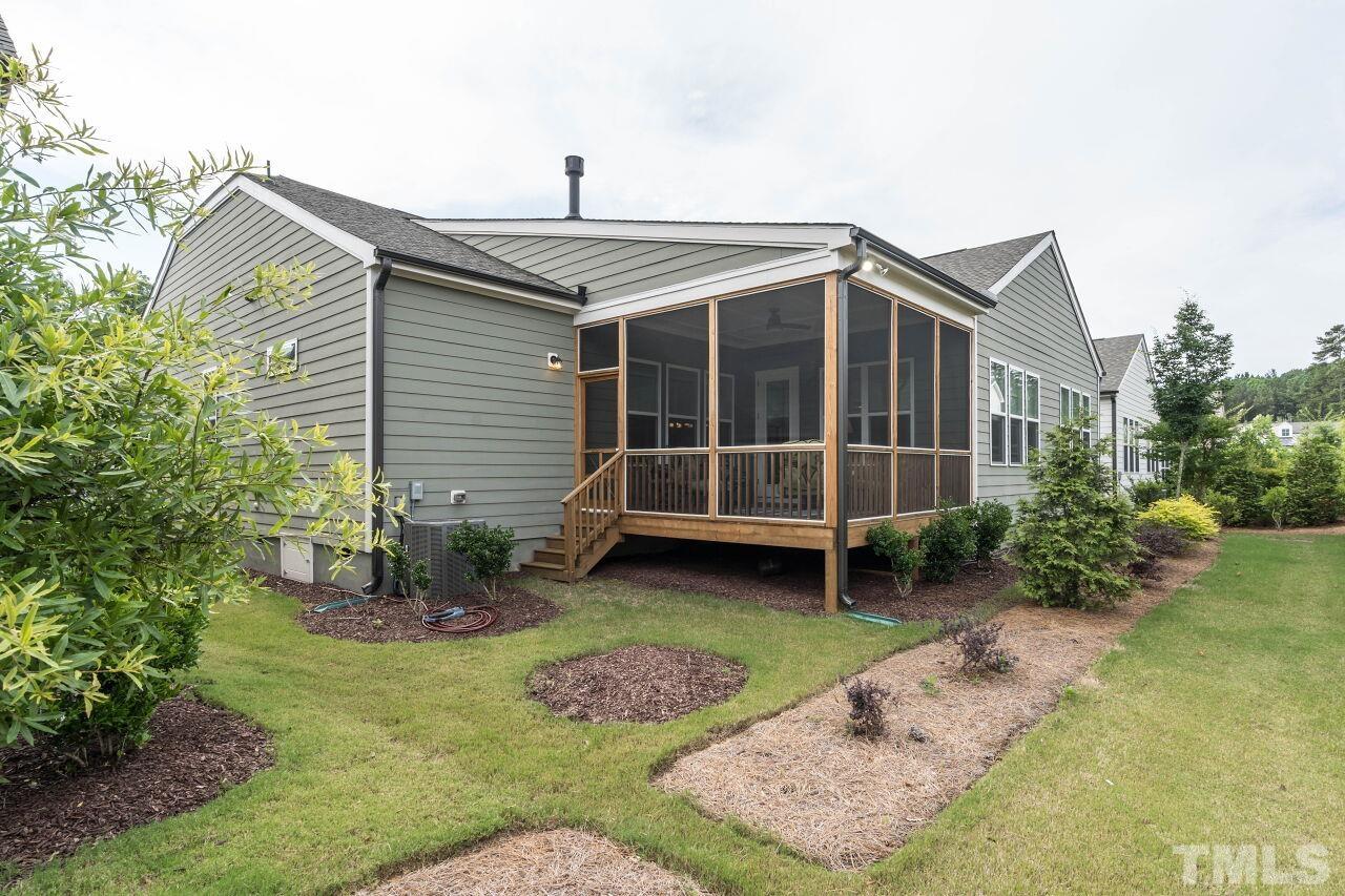 129 Damsire Way Cary, NC 27513 - Photo 31 of 32 a front view of a house with a garden and yard