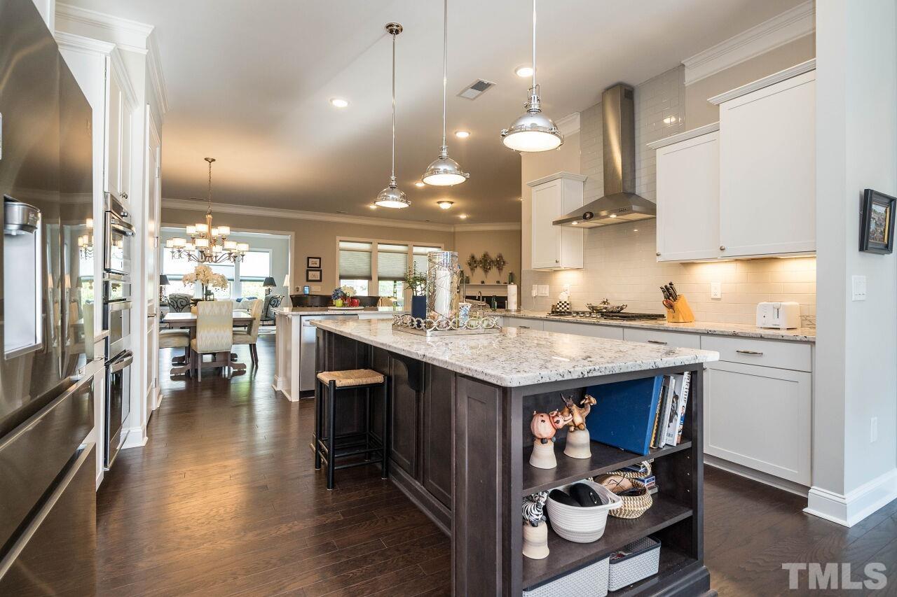 129 Damsire Way Cary, NC 27513 - Photo 7 of 32 a kitchen with stainless steel appliances granite countertop a lot of counter space and a sink