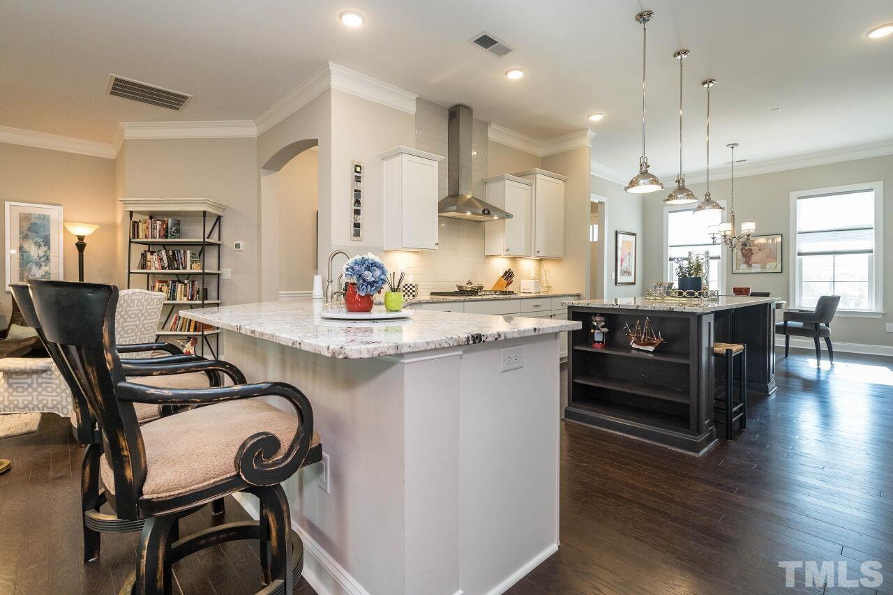 129 Damsire Way Cary, NC 27513 - Photo 10 of 32 a large kitchen with kitchen island a table and chairs in it
