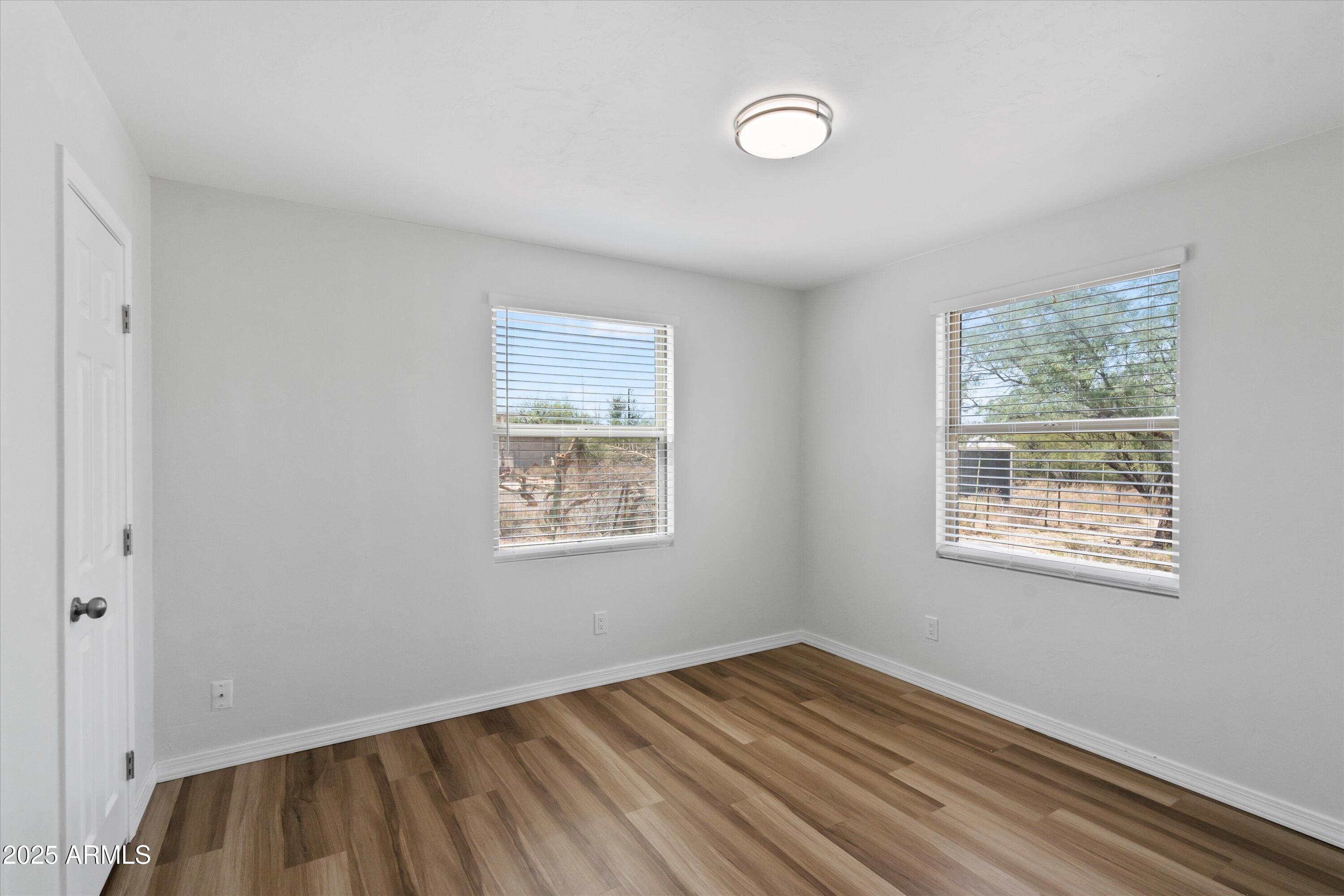 468 West Duane Street Benson, AZ 85602 - Photo 15 of 21 a view of an empty room with wooden floor and a window
