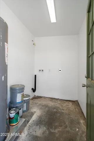 a view of a patio with dining table and chairs under an umbrella with a barbeque