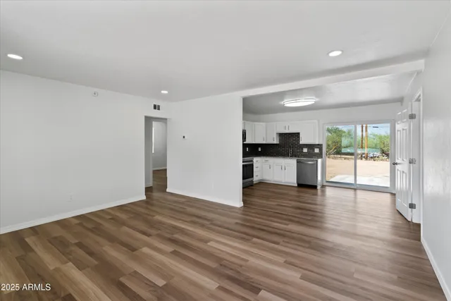 a view of a kitchen with wooden floor and a kitchen