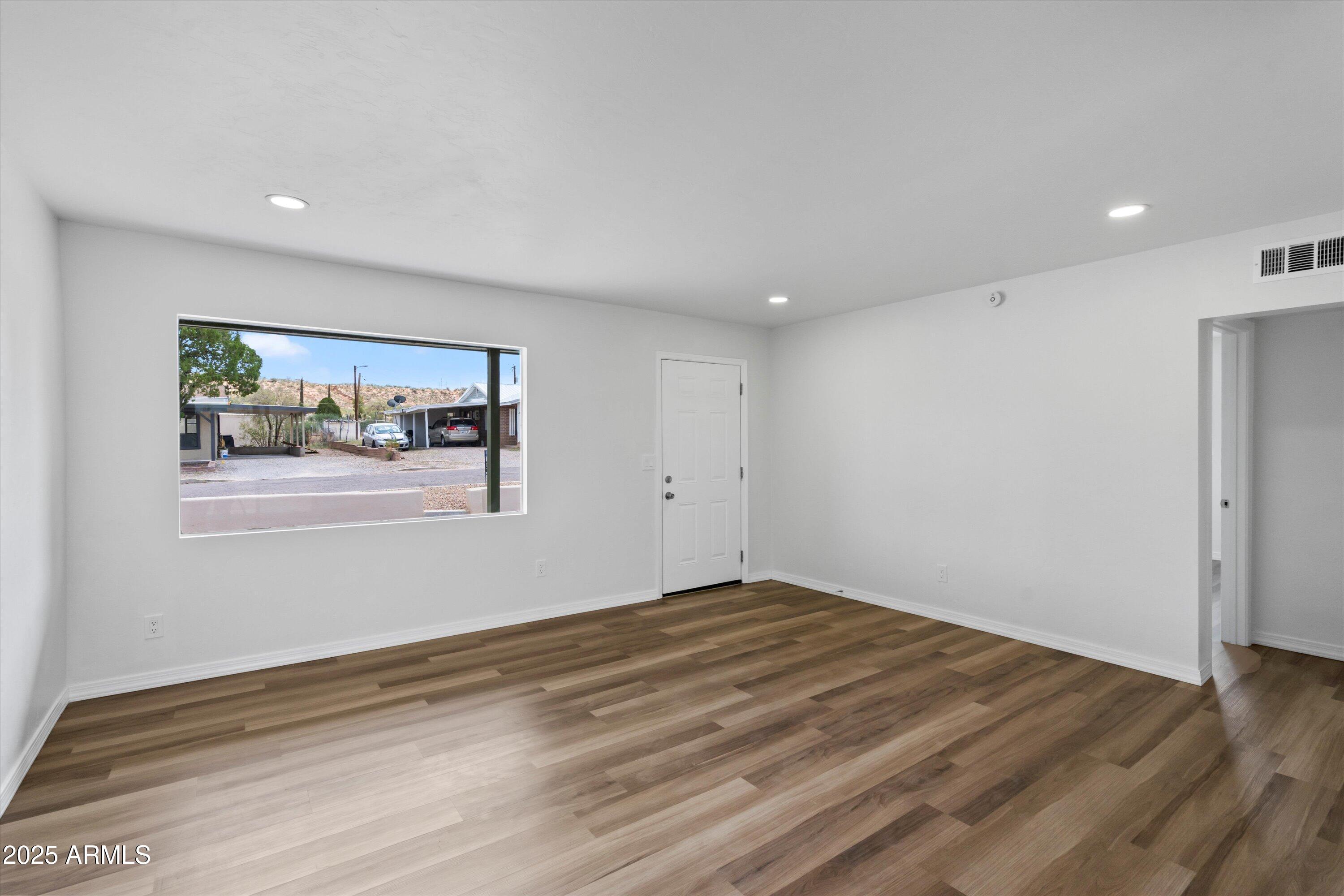 468 West Duane Street Benson, AZ 85602 - Photo 4 of 21 a view of empty room with wooden floor