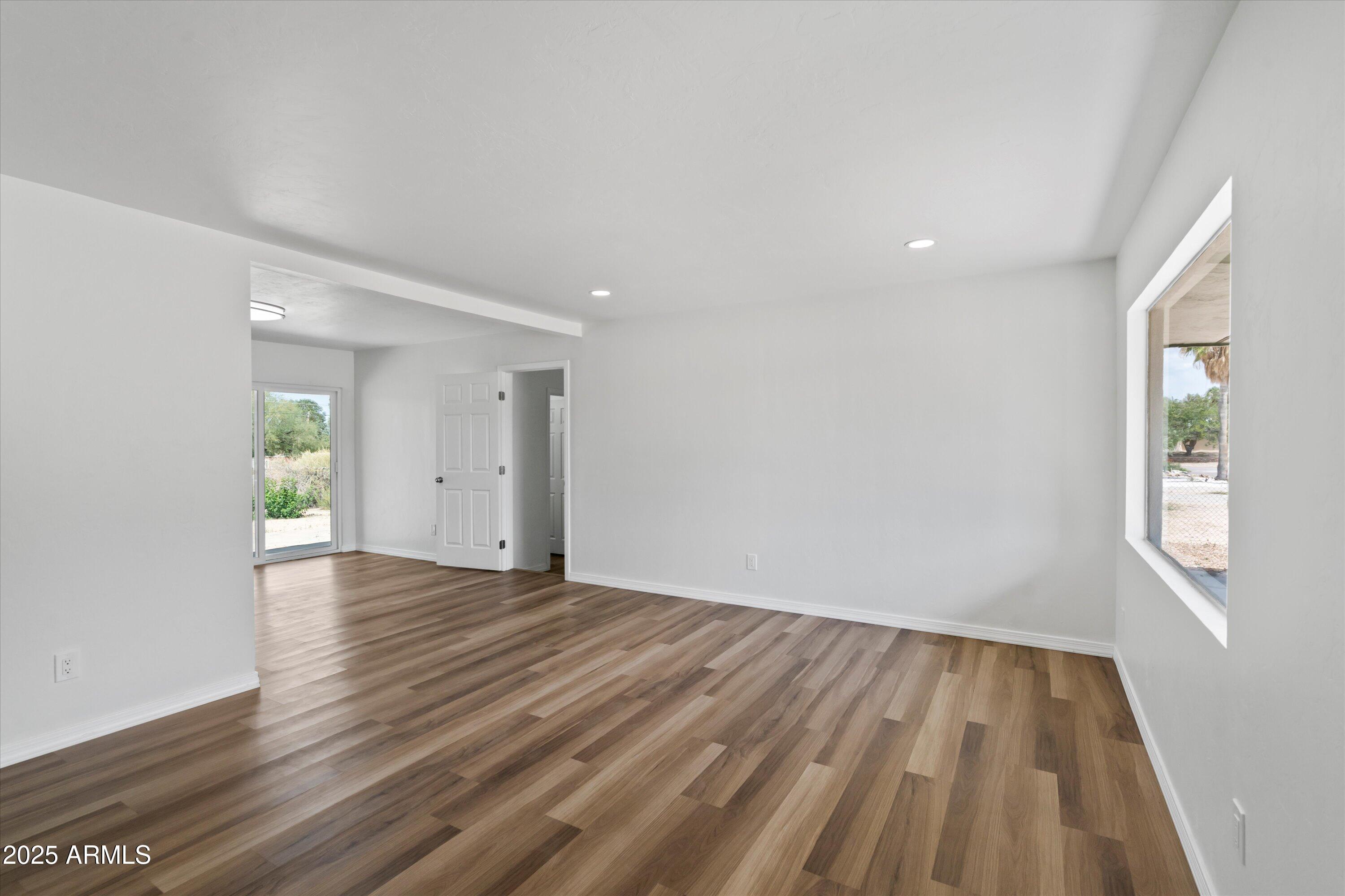 468 West Duane Street Benson, AZ 85602 - Photo 5 of 21 a view of an empty room with wooden floor and a window