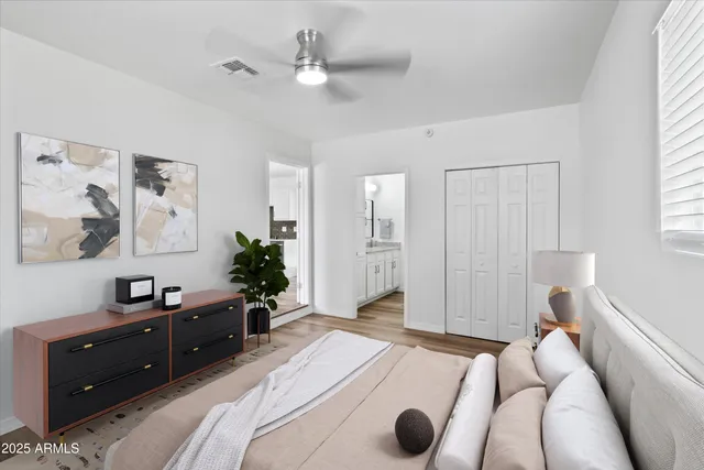 a spacious bedroom with a bed and a dresser