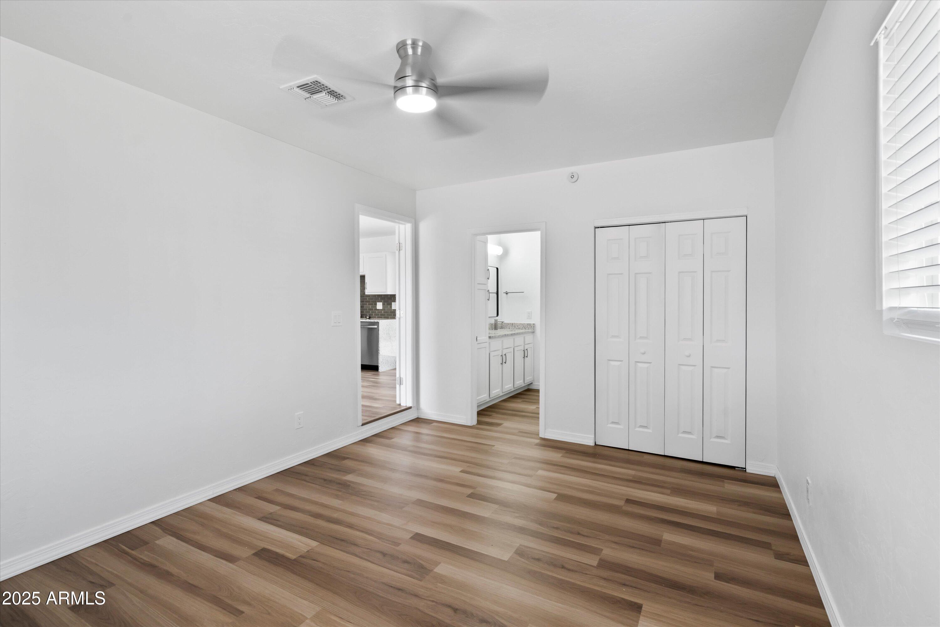 468 West Duane Street Benson, AZ 85602 - Photo 9 of 21 wooden floor in an empty room with a window