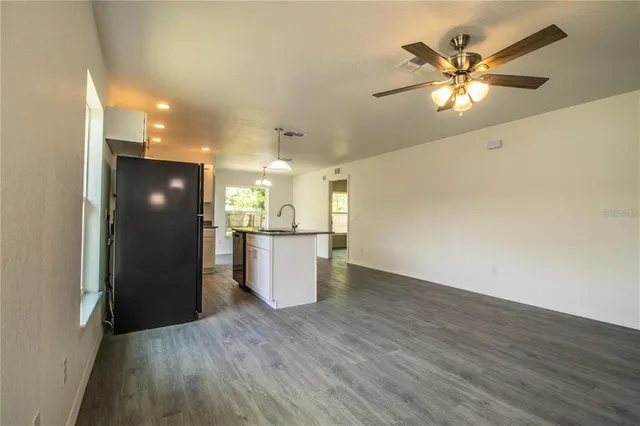 a view of a kitchen with a sink and a refrigerator