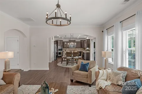 a living room with furniture a rug and a chandelier