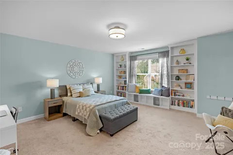 a bedroom with a bed furniture and a large window