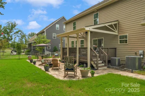 a view of a house with backyard porch and sitting area