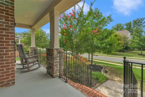 a view of a porch with a table and chairs