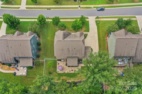 an aerial view of a house with garden space and street view