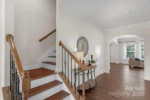 a view of entryway and hall with wooden floor