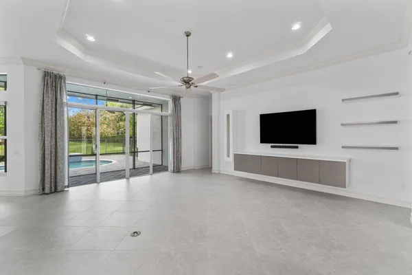 a view of an empty room with a flat screen tv and outdoor view