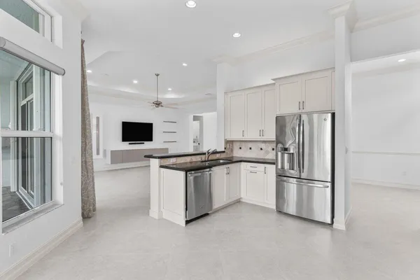 a kitchen with stainless steel appliances refrigerator and microwave