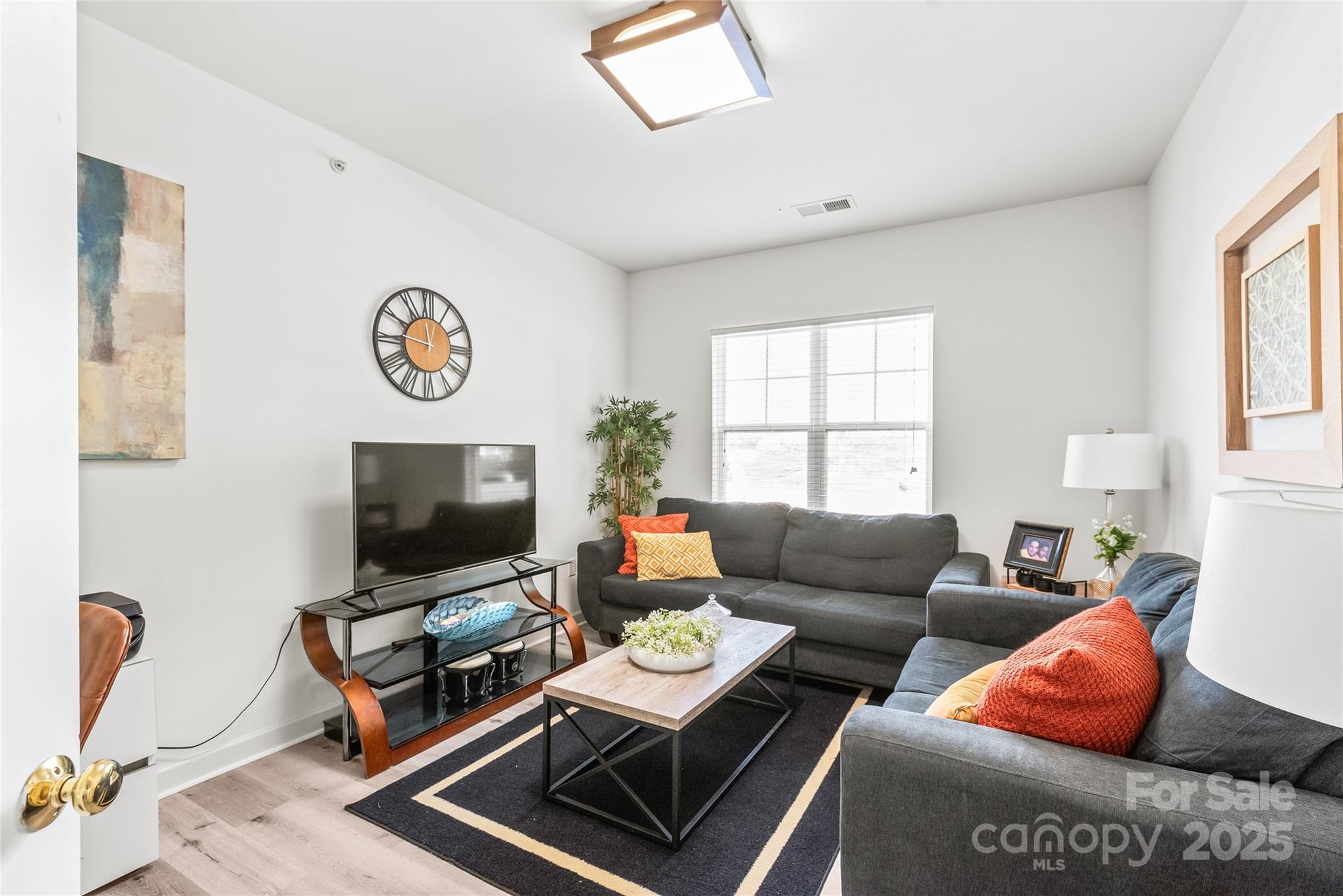 12357 Copper Mountain Boulevard Charlotte, NC 28277 - Photo 19 of 36 a living room with furniture and a flat screen tv