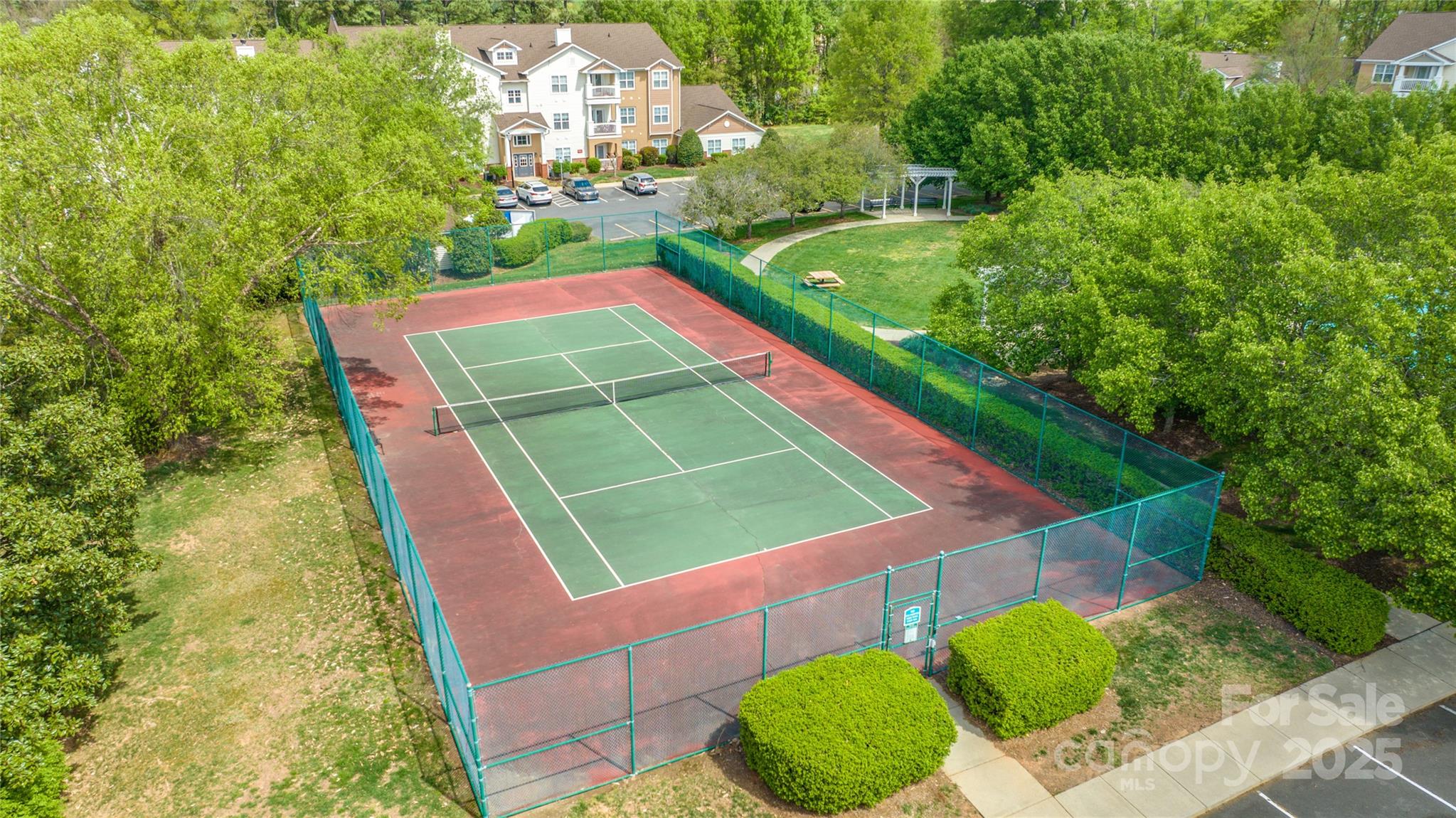 12357 Copper Mountain Boulevard Charlotte, NC 28277 - Photo 31 of 36 a view of a tennis ground with a large pool