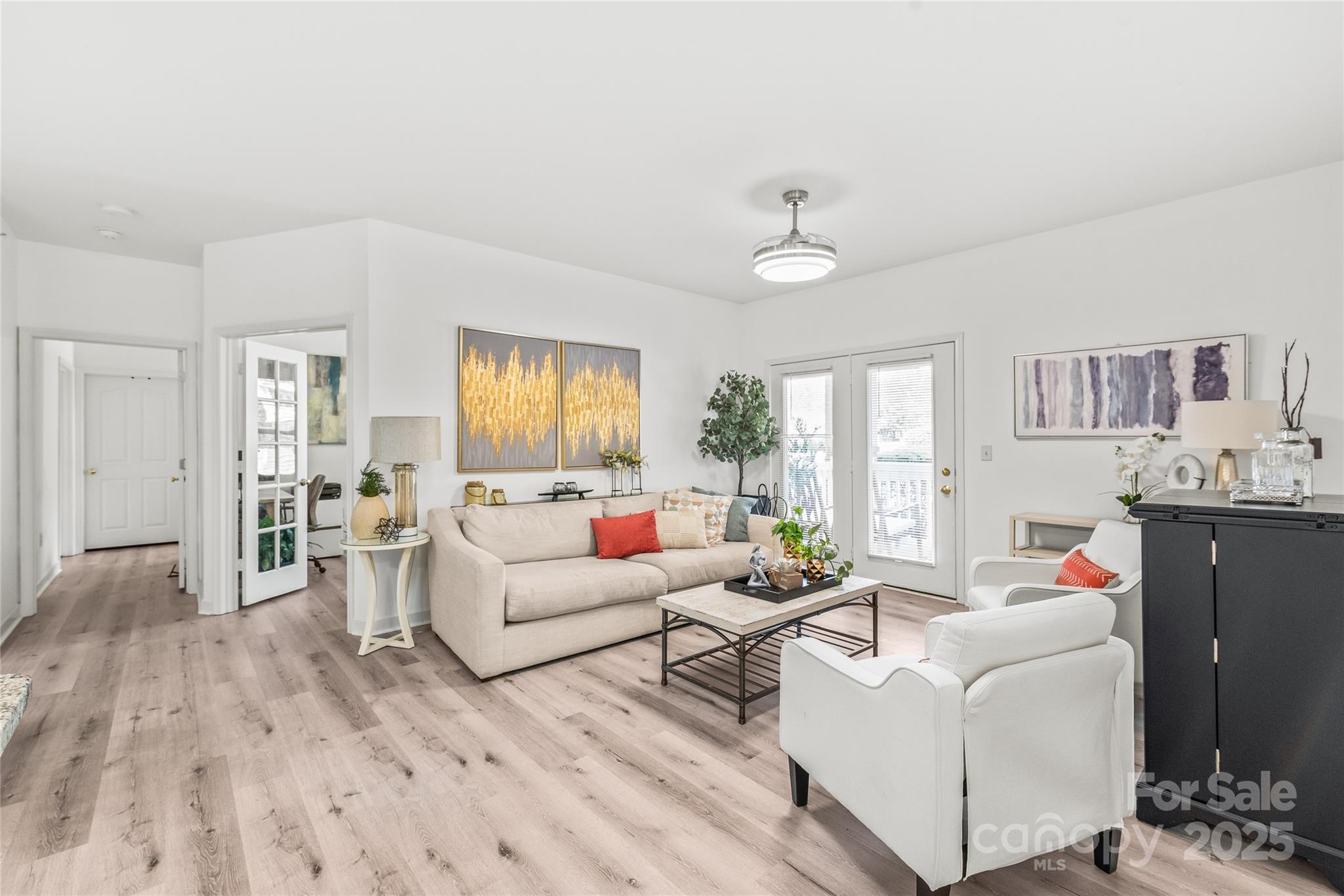 12357 Copper Mountain Boulevard Charlotte, NC 28277 - Photo 10 of 36 a living room with furniture and a wooden floor