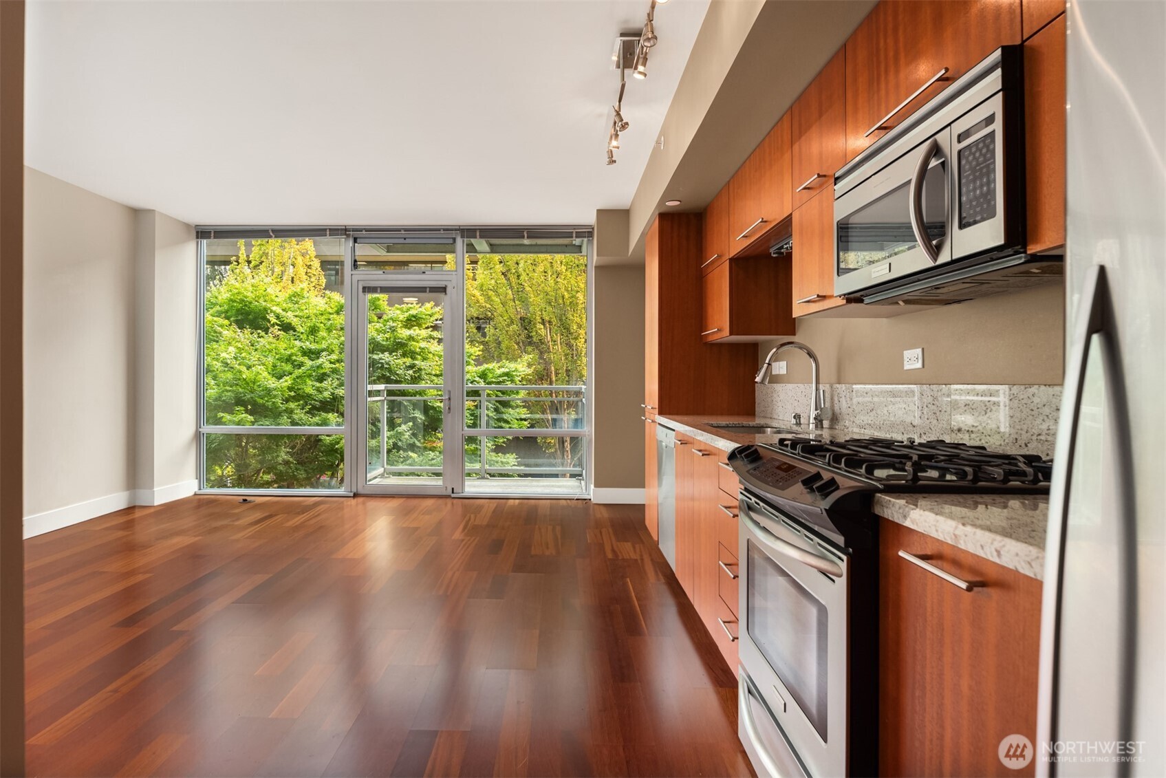 2911 2nd Avenue, Unit 310 Seattle, WA 98121 - Photo 12 of 40 a kitchen with stainless steel appliances granite countertop a stove and a sink