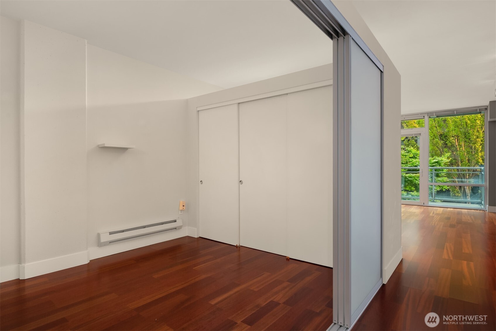 2911 2nd Avenue, Unit 310 Seattle, WA 98121 - Photo 15 of 40 wooden floor in an empty room with a window