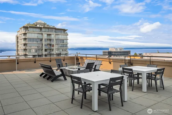 a terrace with outdoor seating and city view