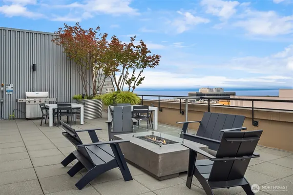 a view of a patio with dining table and chairs with wooden fence and plants