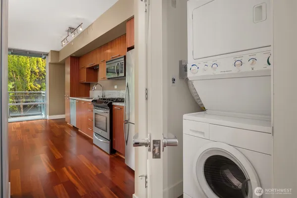 a kitchen with granite countertop wooden cabinets and stainless steel appliances