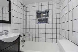 a bathroom with a bathtub and shower