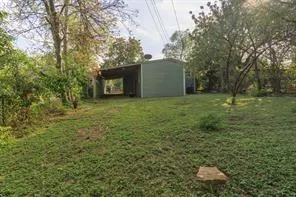 a view of a backyard with large trees