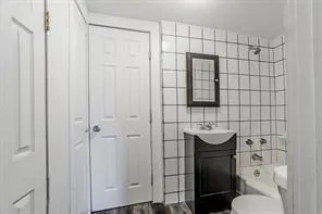a bathroom with a toilet sink and shower