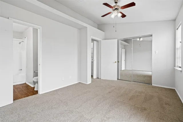 a view of a livingroom with a ceiling fan & a ceiling fan