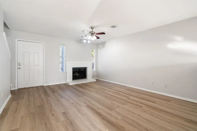 a view of empty room with a fireplace