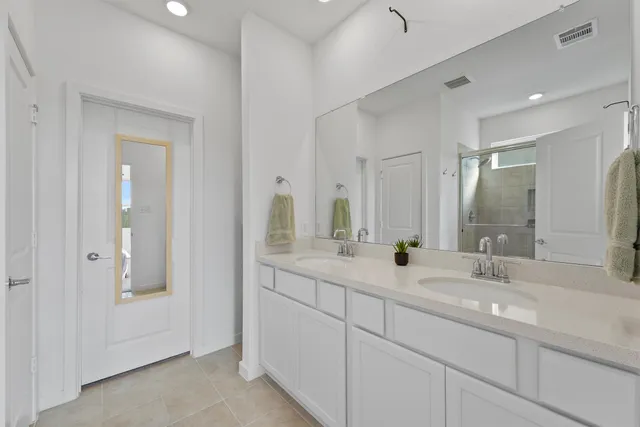 a bathroom with a granite countertop shower mirror and a sink