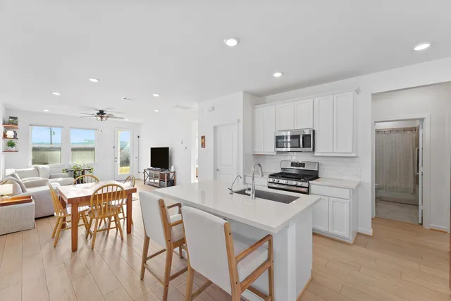 a kitchen with refrigerator cabinets and wooden floor