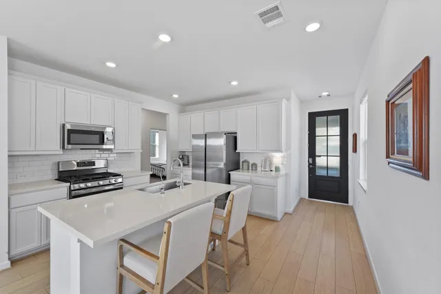 a kitchen with sink cabinets and living room