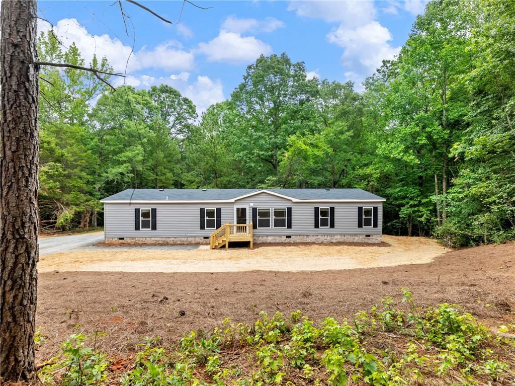 251 Cedar Ridge Drive Commerce, GA 30530 - Photo 1 of 1 a front view of a house with a yard and trees