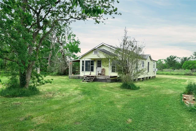 a front view of a house with yard porch and green space