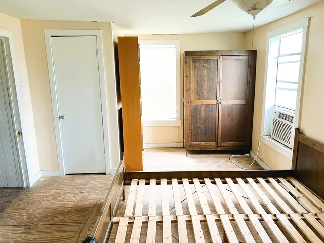 a bedroom with a bed and a window