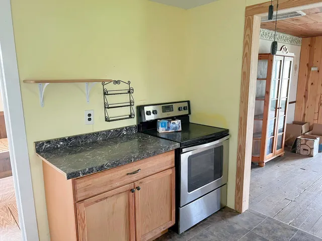a kitchen with stainless steel appliances granite countertop a sink and a stove
