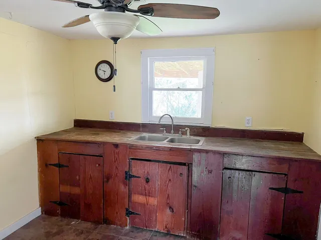 a kitchen with stainless steel appliances granite countertop a refrigerator a stove and a sink