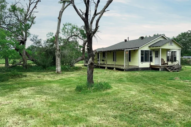 a front view of a house with yard porch and furniture