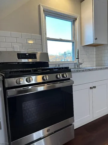a stove top oven sitting inside of a kitchen